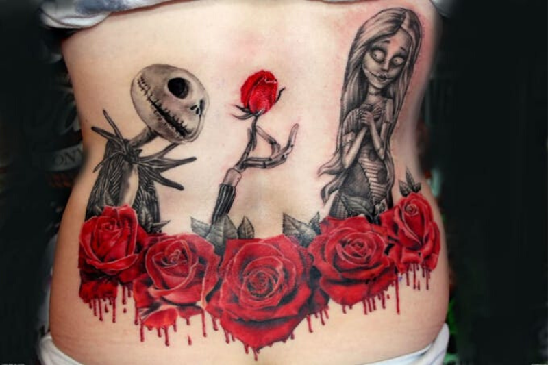 Nightmare Before Christmas tattoo on a person's back showing Jack Skellington handing a rose to Sally