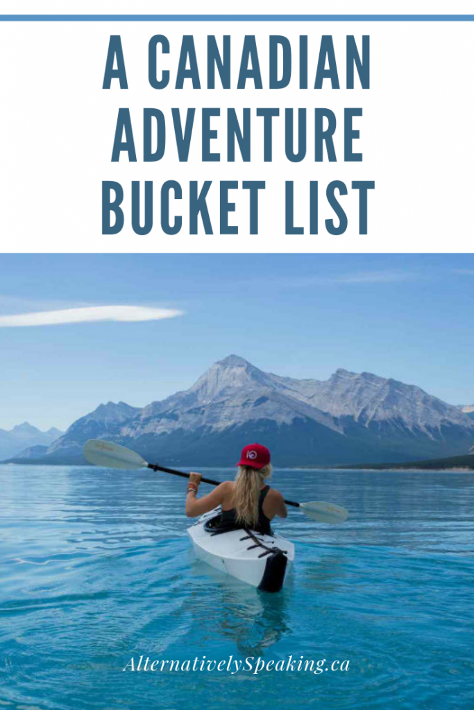 woman kayaking in a large body of water with mountains in the background with the title a Canadian adventure bucket list