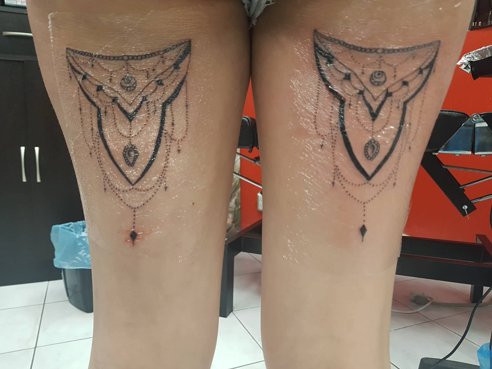 a set of lace thigh tattoos recently completed