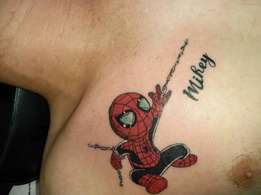 a tattoo of spiderman with the name 'Mikey'