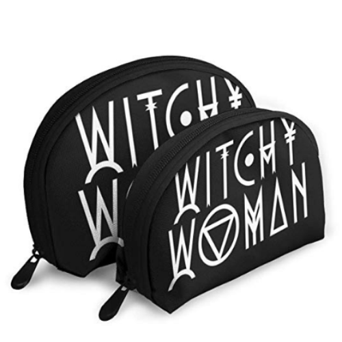 two black cosmetic bags sitting side by side with the words 'witchy woman' on them in white