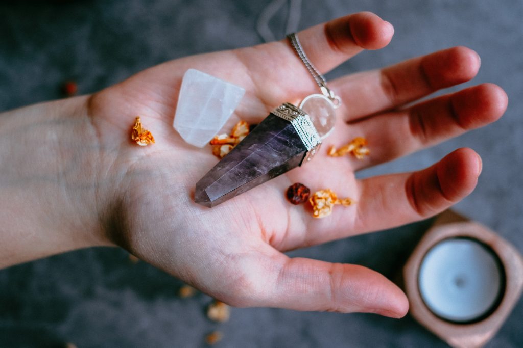 hand holding crystals used for rituals