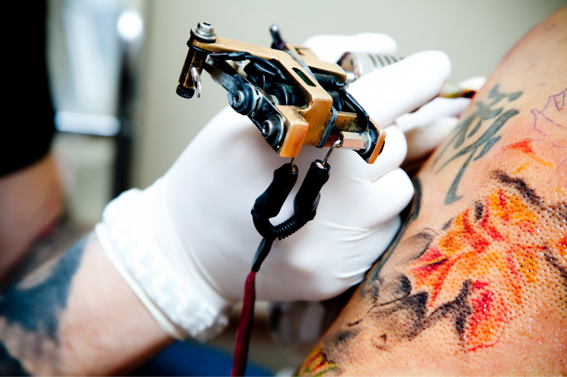 tattoo artist working on tattoo | Things to Consider Before Getting a Tattoo