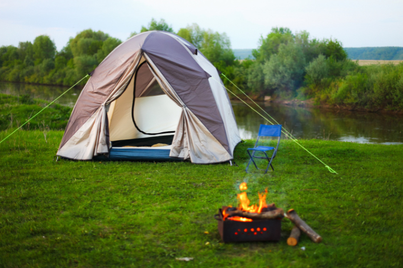 tent and campfire | The Camping Essentials You’ll Need for Your Next Adventure